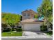 Charming two-story home with a well-manicured front lawn and attached two-car garage at 916 Pro Players Dr, Las Vegas, NV 89134