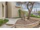 Charming home with a tree and landscaped front yard, surrounded by a decorative wrought iron fence at 916 Pro Players Dr, Las Vegas, NV 89134