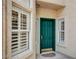 Inviting front entrance featuring a bright green door, detailed trim, and beautiful sidelight windows at 916 Pro Players Dr, Las Vegas, NV 89134