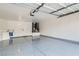 Spacious two-car garage featuring epoxy flooring, storage, and a utility sink at 916 Pro Players Dr, Las Vegas, NV 89134