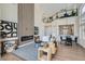 Open-concept living space with modern fireplace, view of the kitchen, and bright natural light at 916 Pro Players Dr, Las Vegas, NV 89134
