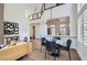 Bright open-concept living room featuring a modern dining area, stylish chandelier, and soaring ceilings at 916 Pro Players Dr, Las Vegas, NV 89134