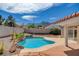 Inviting pool area with stone accents and views of surrounding desert landscape at 9337 Quail Ridge Dr, Las Vegas, NV 89134