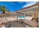 Beautiful backyard featuring a covered patio and refreshing blue swimming pool at 9337 Quail Ridge Dr, Las Vegas, NV 89134
