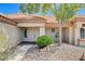 Front entrance featuring double doors, stone landscaping, and a beige exterior at 9337 Quail Ridge Dr, Las Vegas, NV 89134