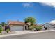 View of single-story home with a tile roof, attached garage, and desert landscaping at 9337 Quail Ridge Dr, Las Vegas, NV 89134