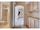 Hallway leading to a bathroom and other rooms with storage cabinets at 9337 Quail Ridge Dr, Las Vegas, NV 89134