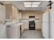 Kitchen with neutral cabinets, tile floors, and stainless steel range at 9337 Quail Ridge Dr, Las Vegas, NV 89134