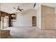 Open living room featuring a brick fireplace, vaulted ceilings, and lots of natural light at 9337 Quail Ridge Dr, Las Vegas, NV 89134