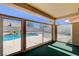 Screened in patio boasts views of the pool and backyard with clear glass windows at 9337 Quail Ridge Dr, Las Vegas, NV 89134