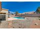 Backyard view of private pool with desert landscaping under a bright blue sky at 9337 Quail Ridge Dr, Las Vegas, NV 89134