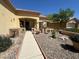 Charming front yard with desert landscaping, rock features, and a cozy seating area at 9816 Villa Ridge Dr, Las Vegas, NV 89134
