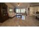 Bright living room with large windows, tile flooring, and classic furnishings at 9816 Villa Ridge Dr, Las Vegas, NV 89134