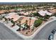 Aerial view of a suburban neighborhood featuring homes with red tile roofs and palm trees at 11009 Summers End Ave, Las Vegas, NV 89134