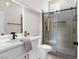 Bright bathroom showcasing a glass-enclosed shower, toilet, and modern vanity at 11009 Summers End Ave, Las Vegas, NV 89134