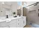 Stylish bathroom showcasing double sinks, quartz counters and a sleek glass shower enclosure at 11009 Summers End Ave, Las Vegas, NV 89134