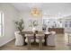 Light filled dining room featuring designer light fixture, modern table and contemporary decor at 11009 Summers End Ave, Las Vegas, NV 89134