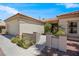 Attractive home exterior featuring a gated entry, desert landscaping, and a neutral color scheme at 11009 Summers End Ave, Las Vegas, NV 89134