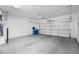 Spacious two car garage with white walls and a roll-up door at 11009 Summers End Ave, Las Vegas, NV 89134