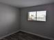 Bright bedroom with wood-look flooring and natural light from window at 1220 Toledo St, Henderson, NV 89015