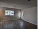 Living room with wood-look floors and large windows allowing natural light at 1220 Toledo St, Henderson, NV 89015
