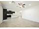 Bright, open-concept area connecting the living space to a modern kitchen with wood-style tile floors and neutral walls at 12426 Mosticone Way, Las Vegas, NV 89141