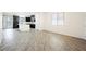Open living space with wood-style tile flooring, connecting the kitchen, dining, and living areas with lots of natural light at 12426 Mosticone Way, Las Vegas, NV 89141