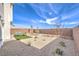 Spacious backyard with desert landscaping, a seating area, and a privacy wall at 1289 Miller Springs Ln # 96, North Las Vegas, NV 89084
