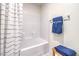 Bright bathroom featuring a shower over tub, tile surround, and blue decorative towels at 1289 Miller Springs Ln # 96, North Las Vegas, NV 89084