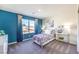 Stylish bedroom with a bright accent wall, large window and a dedicated workspace at 1289 Miller Springs Ln # 96, North Las Vegas, NV 89084