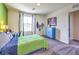 Bright bedroom features a well-lit desk, blue cabinet, and a large window at 1289 Miller Springs Ln # 96, North Las Vegas, NV 89084