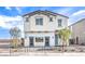 Inviting two-story house featuring light stucco, a tiled roof, and desert landscaping at 1289 Miller Springs Ln # 96, North Las Vegas, NV 89084