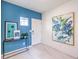 Chic foyer features bright blue accent wall, artwork, and modern console table at 1289 Miller Springs Ln # 96, North Las Vegas, NV 89084