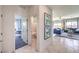 Hallway featuring views of the bathroom and office, leading into the living room with plenty of natural light at 1289 Miller Springs Ln # 96, North Las Vegas, NV 89084