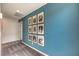 Upstairs hallway with patterned carpet, blue accent wall with gold framed photos at 1289 Miller Springs Ln # 96, North Las Vegas, NV 89084