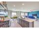 Bright kitchen with gray cabinets, stainless appliances, an island, an eat-in table, and an open floorplan at 1289 Miller Springs Ln # 96, North Las Vegas, NV 89084