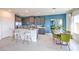 Open kitchen with gray cabinetry, stainless appliances, white quartz countertops, and a marble table at 1289 Miller Springs Ln # 96, North Las Vegas, NV 89084