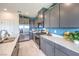 Stylish kitchen features stainless appliances, gray cabinets, and quartz countertops at 1289 Miller Springs Ln # 96, North Las Vegas, NV 89084