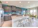 Modern kitchen with stainless steel appliances, gray cabinets, an island with seating, and modern décor at 1289 Miller Springs Ln # 96, North Las Vegas, NV 89084