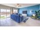 Stylish living room boasts tile floors, a blue accent wall, and sliding glass doors at 1289 Miller Springs Ln # 96, North Las Vegas, NV 89084
