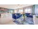 Spacious living area with tile flooring, kitchen view, blue sofa, and modern furnishings at 1289 Miller Springs Ln # 96, North Las Vegas, NV 89084
