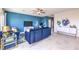 Bright and airy living room with tile floors, a blue accent wall, and modern decor at 1289 Miller Springs Ln # 96, North Las Vegas, NV 89084