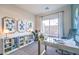 Well-lit home office with modern desk, shelving, and natural light at 1289 Miller Springs Ln # 96, North Las Vegas, NV 89084
