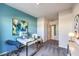Cozy home office with a modern white desk, bright blue accent wall, and natural lighting at 1289 Miller Springs Ln # 96, North Las Vegas, NV 89084
