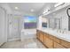 Well-lit bathroom with double sinks, separate shower, and a relaxing tub under a window at 1613 Glenrosa Dr, North Las Vegas, NV 89031
