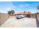Exterior shot featuring a spacious driveway and a vehicle parked alongside the house at 1613 Glenrosa Dr, North Las Vegas, NV 89031