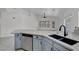 Open kitchen view, showcasing granite countertops, stainless steel dishwasher, and sink with modern faucet at 1613 Glenrosa Dr, North Las Vegas, NV 89031