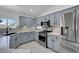 Charming kitchen featuring stainless steel appliances, granite countertops, and blue-gray cabinets at 1613 Glenrosa Dr, North Las Vegas, NV 89031