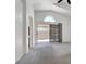 Open-concept living room with vaulted ceilings and sliding doors, showcasing natural light and neutral colors at 1613 Glenrosa Dr, North Las Vegas, NV 89031