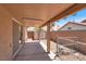 A covered patio features concrete flooring and a view of the backyard, including a storage shed at 1613 Glenrosa Dr, North Las Vegas, NV 89031